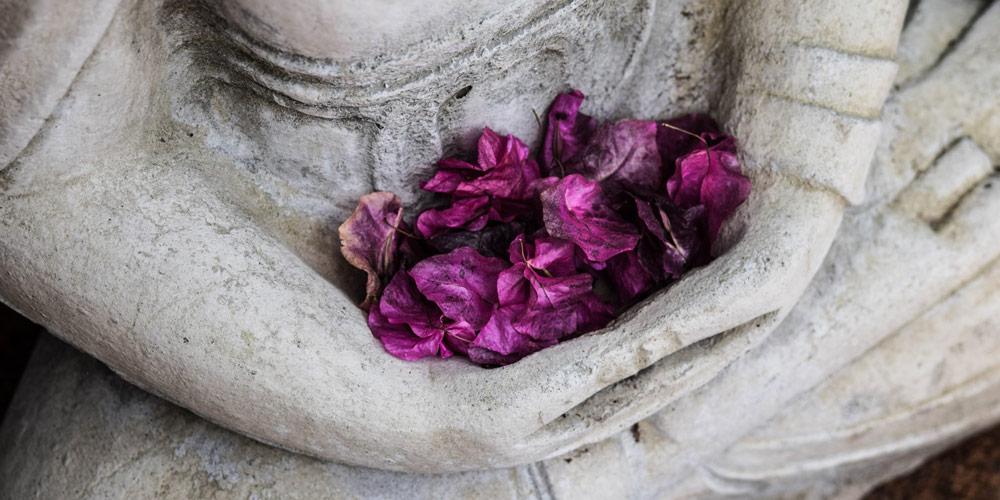 statue with flower leaves in hands patanjali's yoga sutras